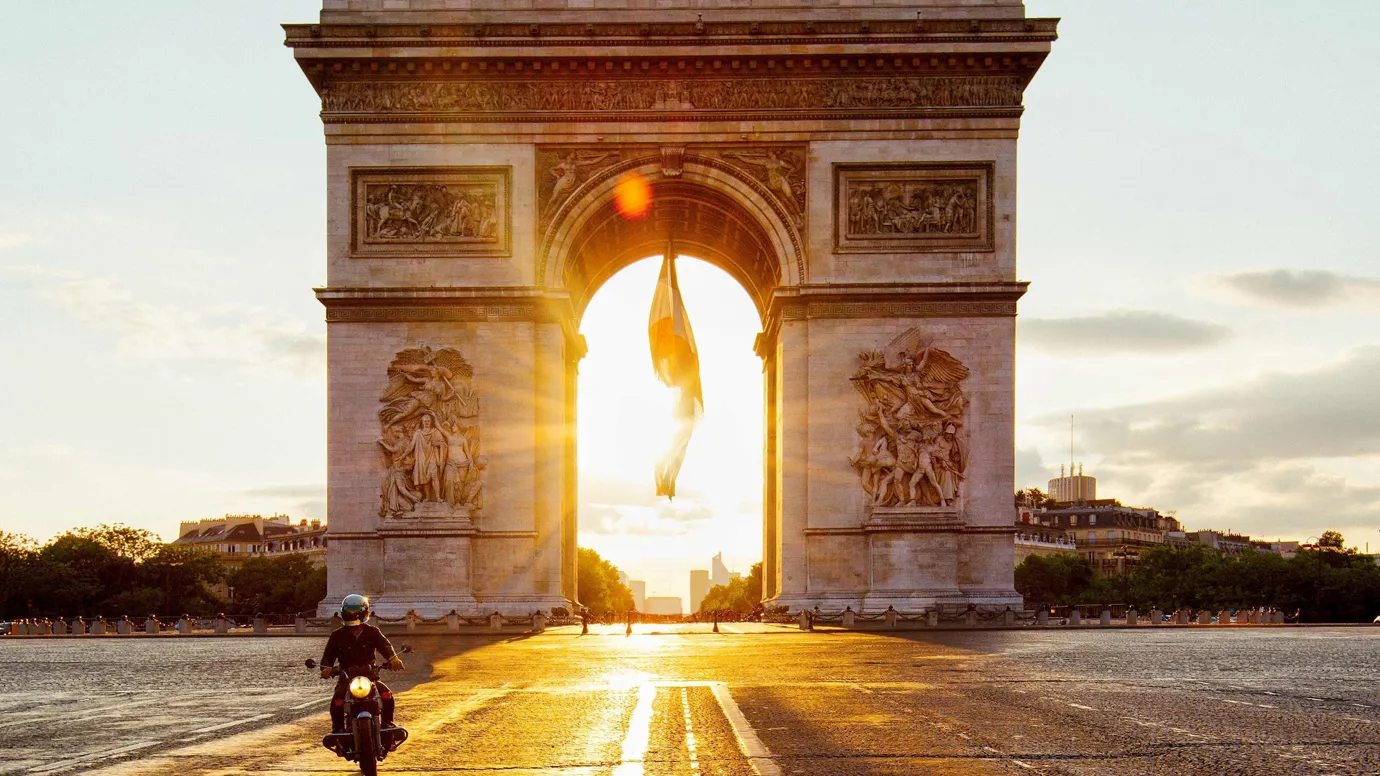 A sunset view of Arc De Triomphe in Paris, France