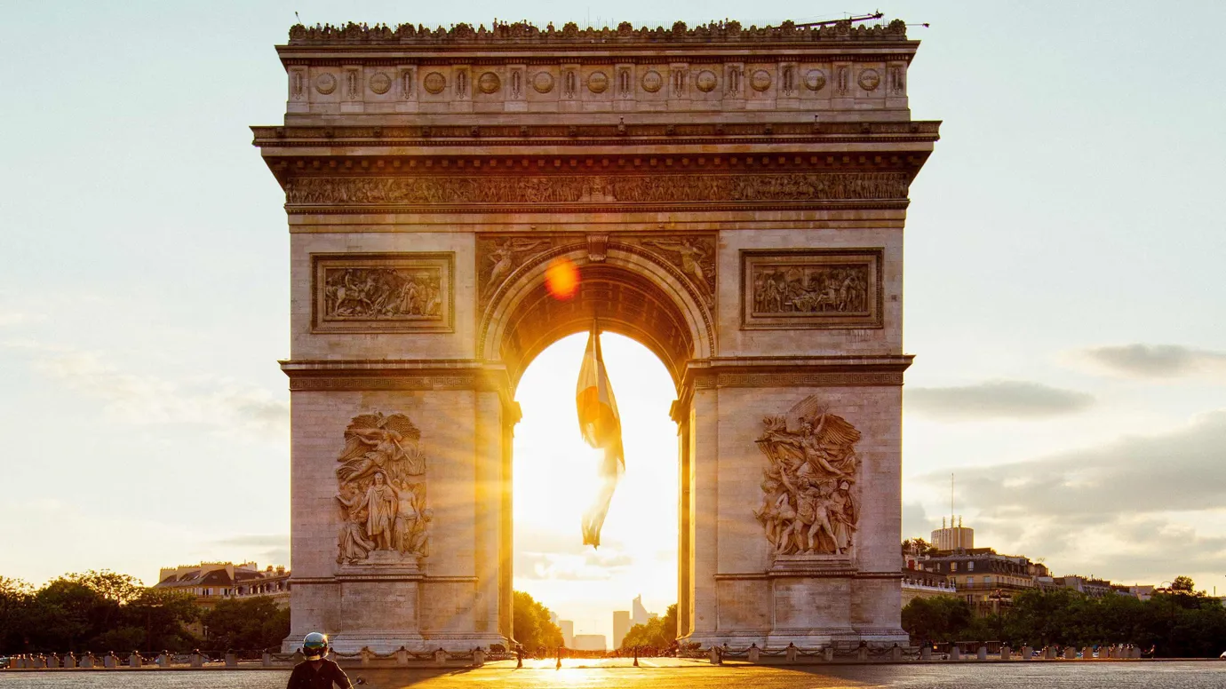A sunset view of Arc De Triomphe in Paris, France