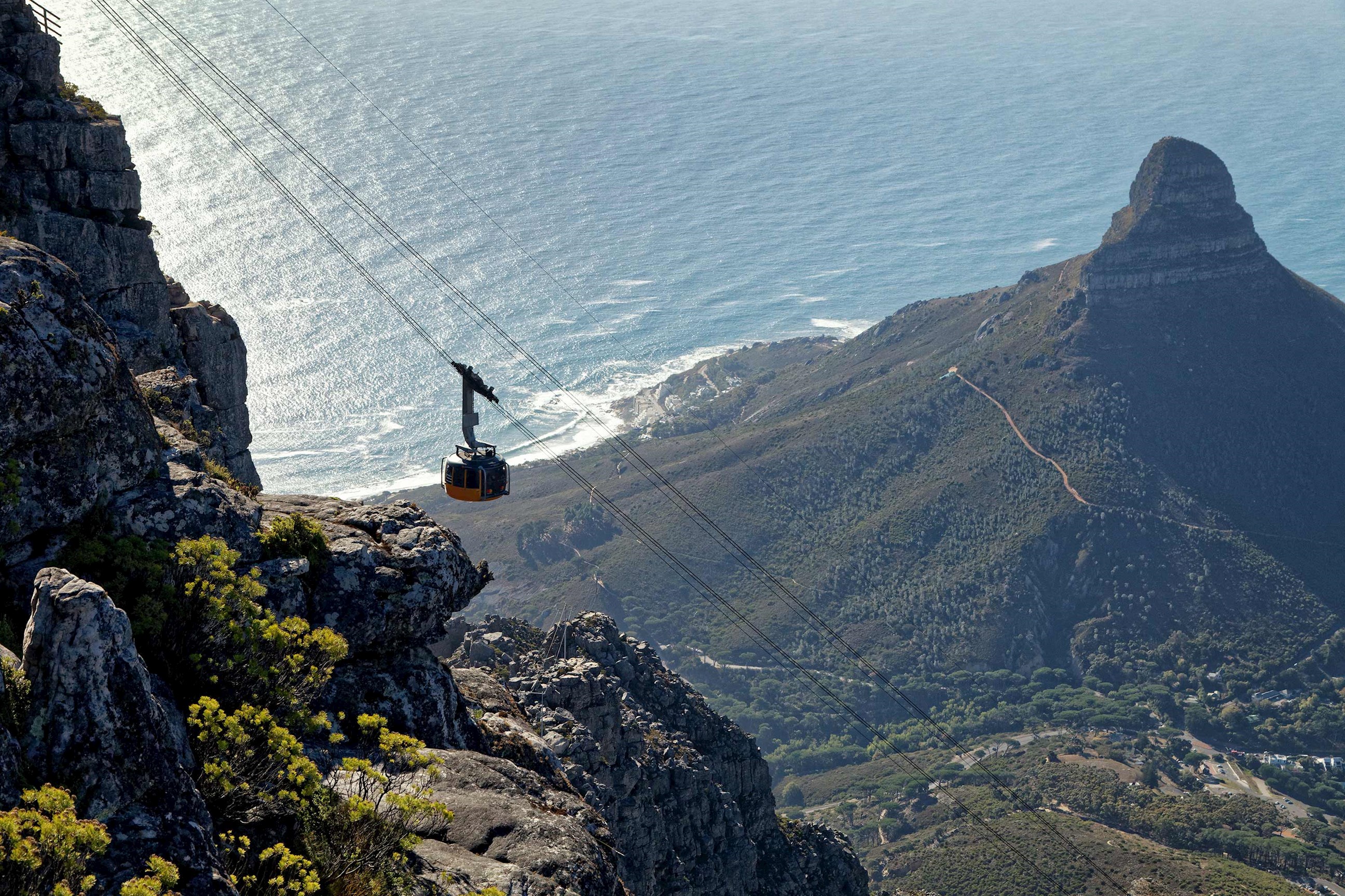 Cable car descending Table Mountain with Atlantic Ocean and Lion’s Head view