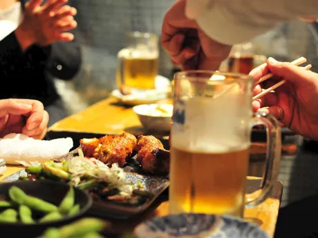 Table full of dishes for tourists experiencing Izakaya Dining in Kyoto, Japan