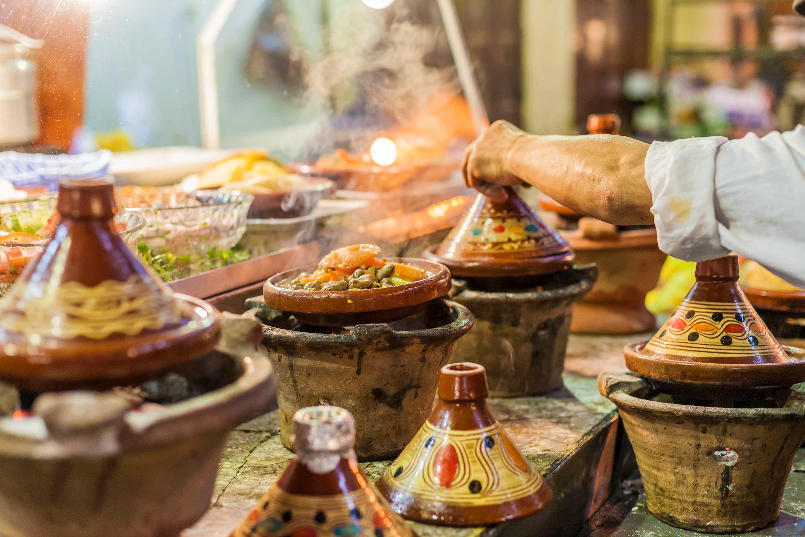 Moroccan tagine pots cooking aromatic dishes at a food stall