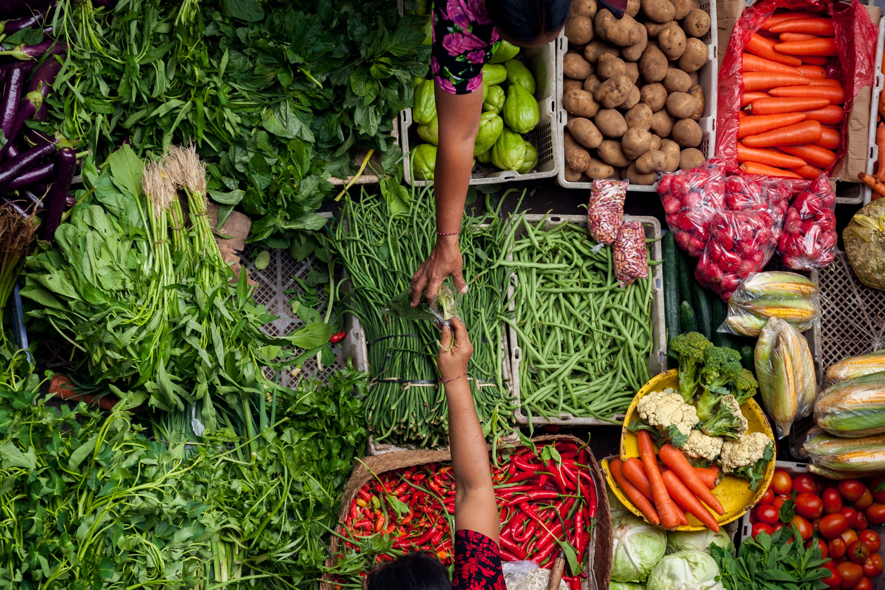 Crates of potatoes, vegetables and chilies on a food market in Bali, Indonesia