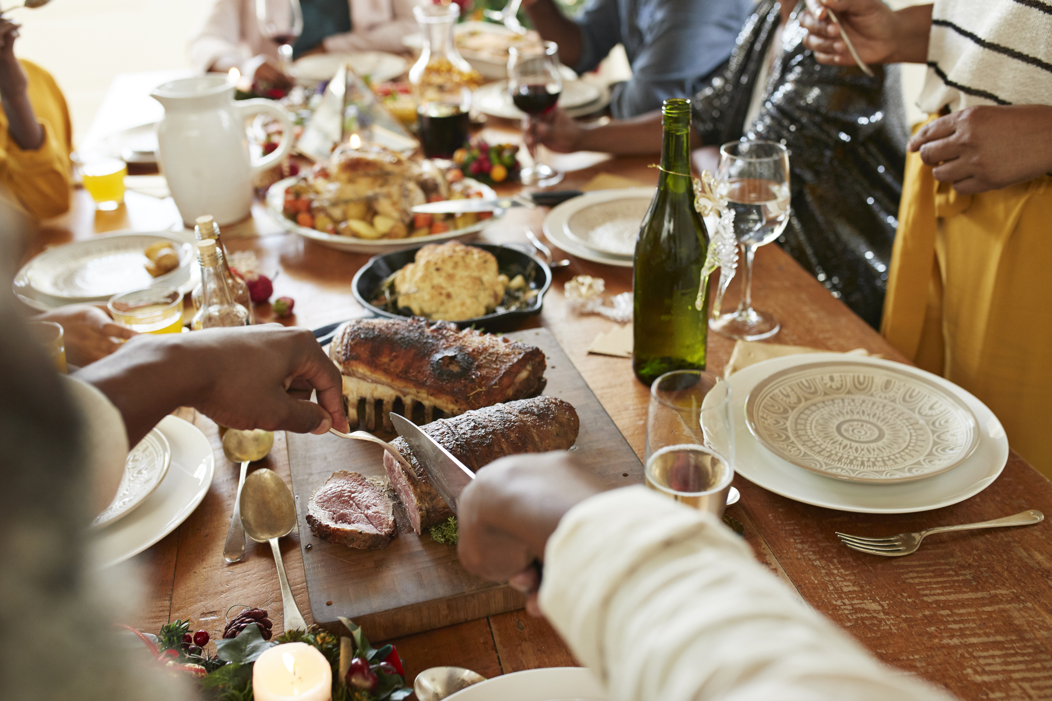 Traditional South African foods on a table with people sat around it