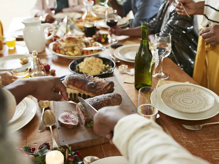 Traditional South African foods on a table with people sat around it