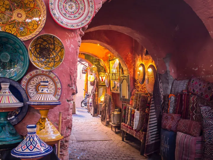 Alleyway in Marrakech filled with traditional goods such as plates and mirrors