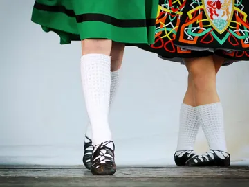 Close-up of Irish dancers’ feet in traditional costumes and soft shoes