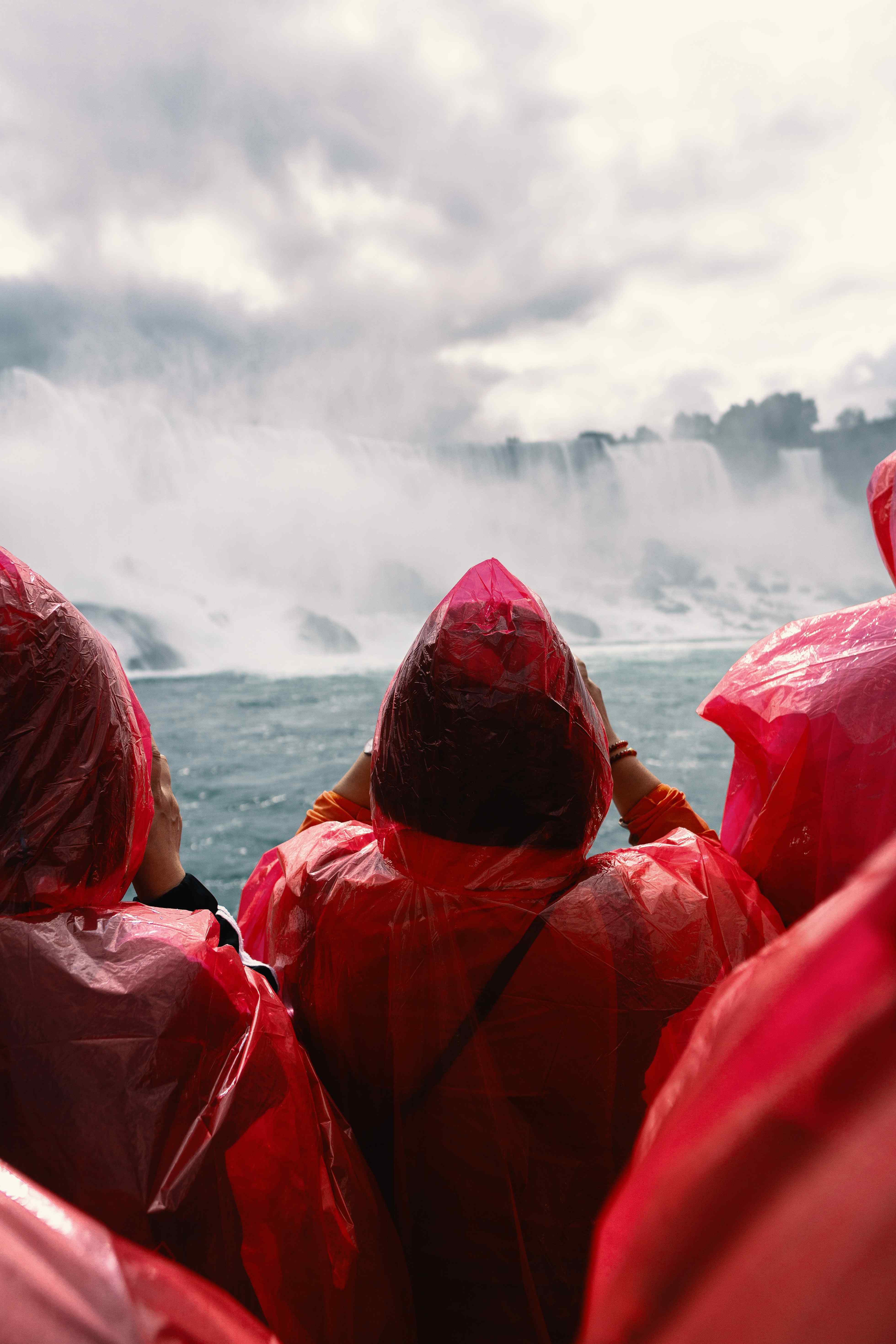 People in red ponchos looking at Niagara Falls in Canada