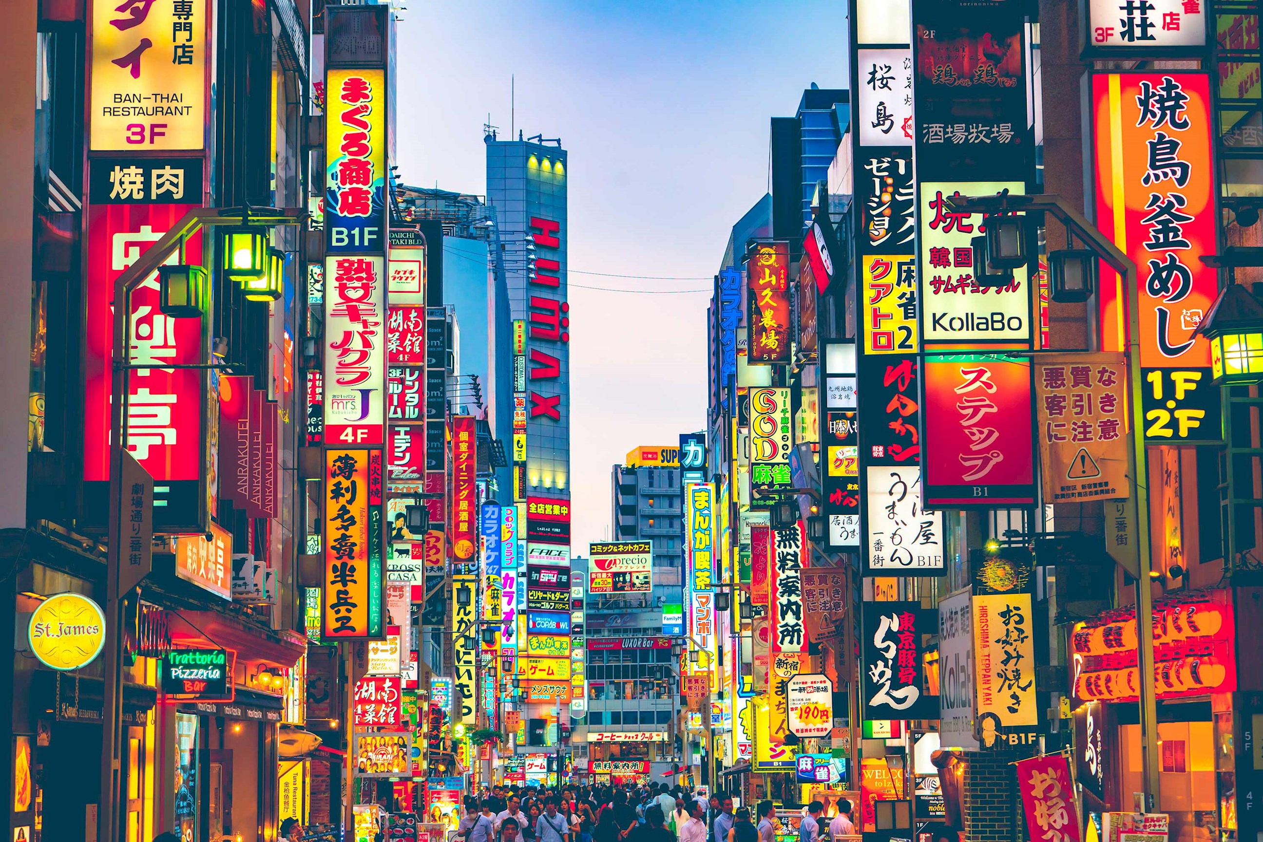 Bustling street with colourful neon signs and crowds in Shinjuku, Tokyo