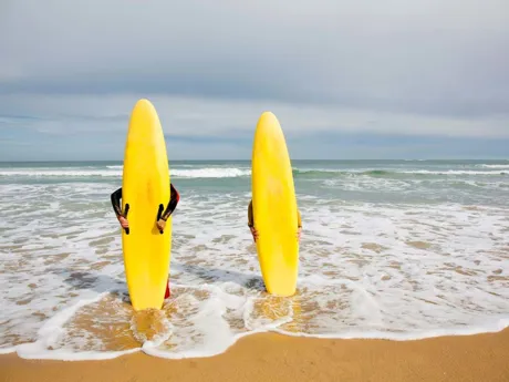 Two Surfers standing in the water in the ocean in Australia