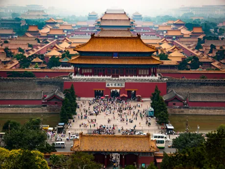 A large temple with red walls and a series of sweeping yellow tiled roofs, located in the Forbidden City, Beijing, China.