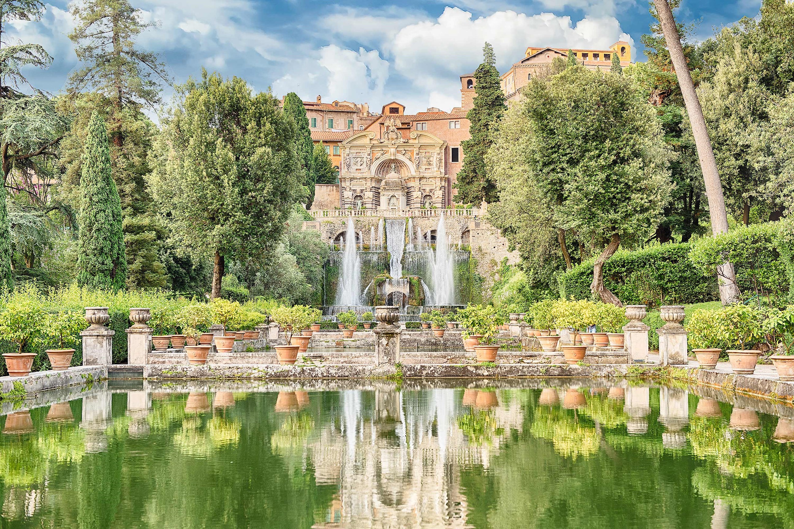Villa d’Este in Tivoli with fountains, terraced gardens and reflective pool surrounded by greenery