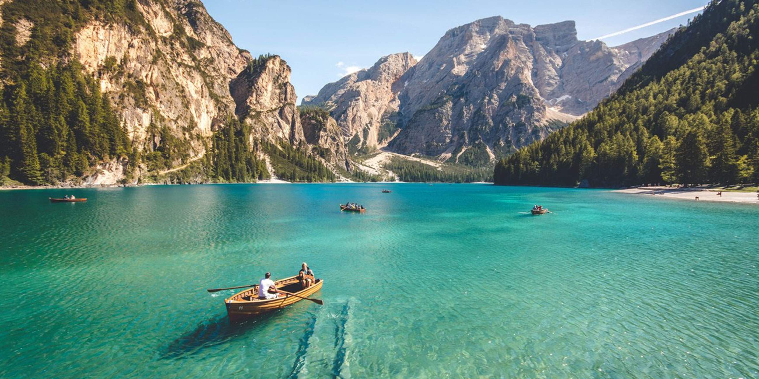 Small boat on a lake surrounded by mountains in Italy