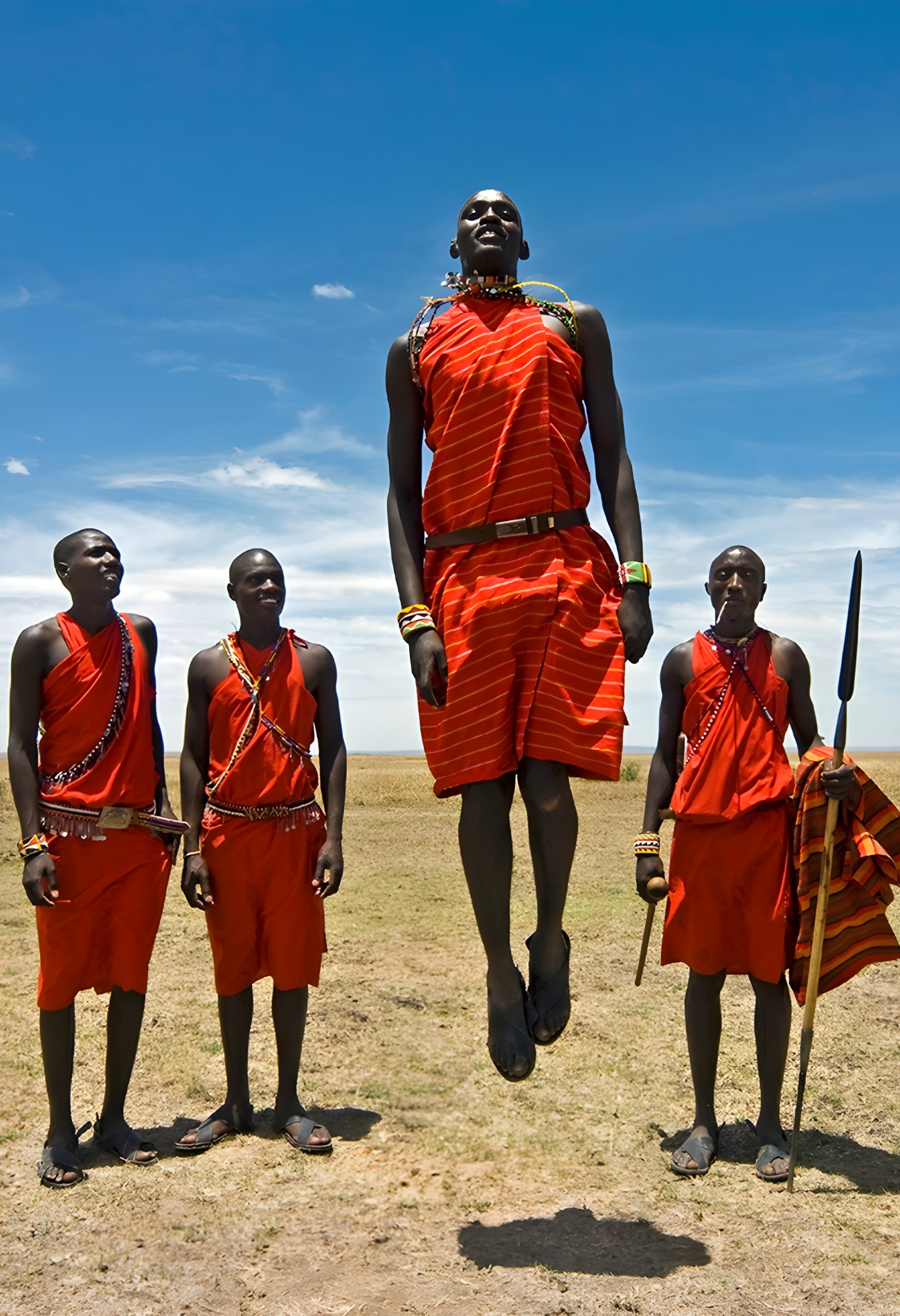 A group of african men standing on a dry grass field in Kenya