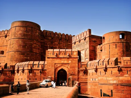 Agra Fort in India, built of rich red stone and with a tall entrance archway.