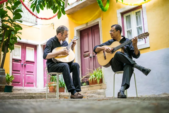 Two Fado Guitarists With Acoustic And Portuguese Guitars In Alfama Lisbon Portugal