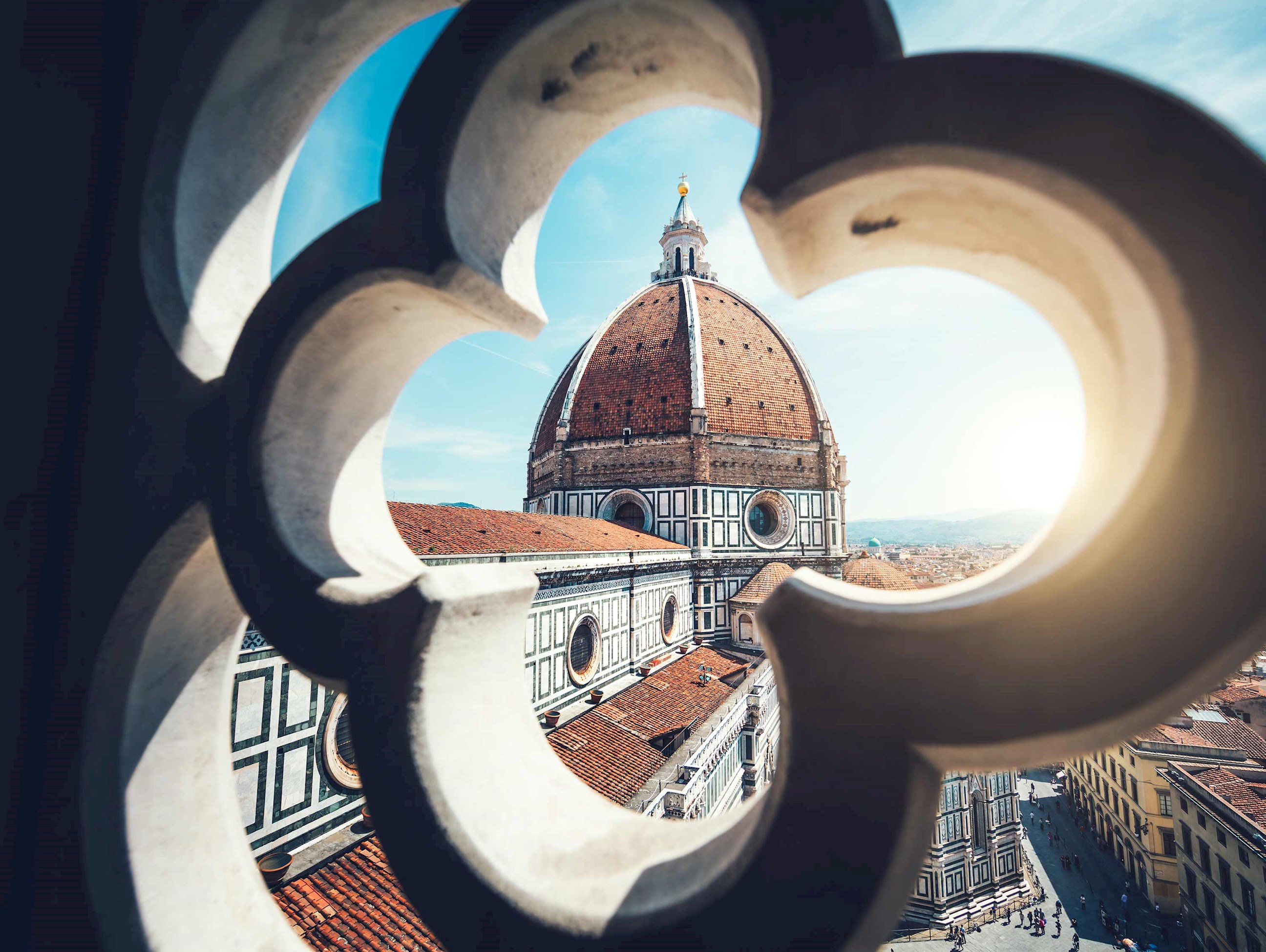 A Cathedral dome view through a decorative stone window in Florence, Italy