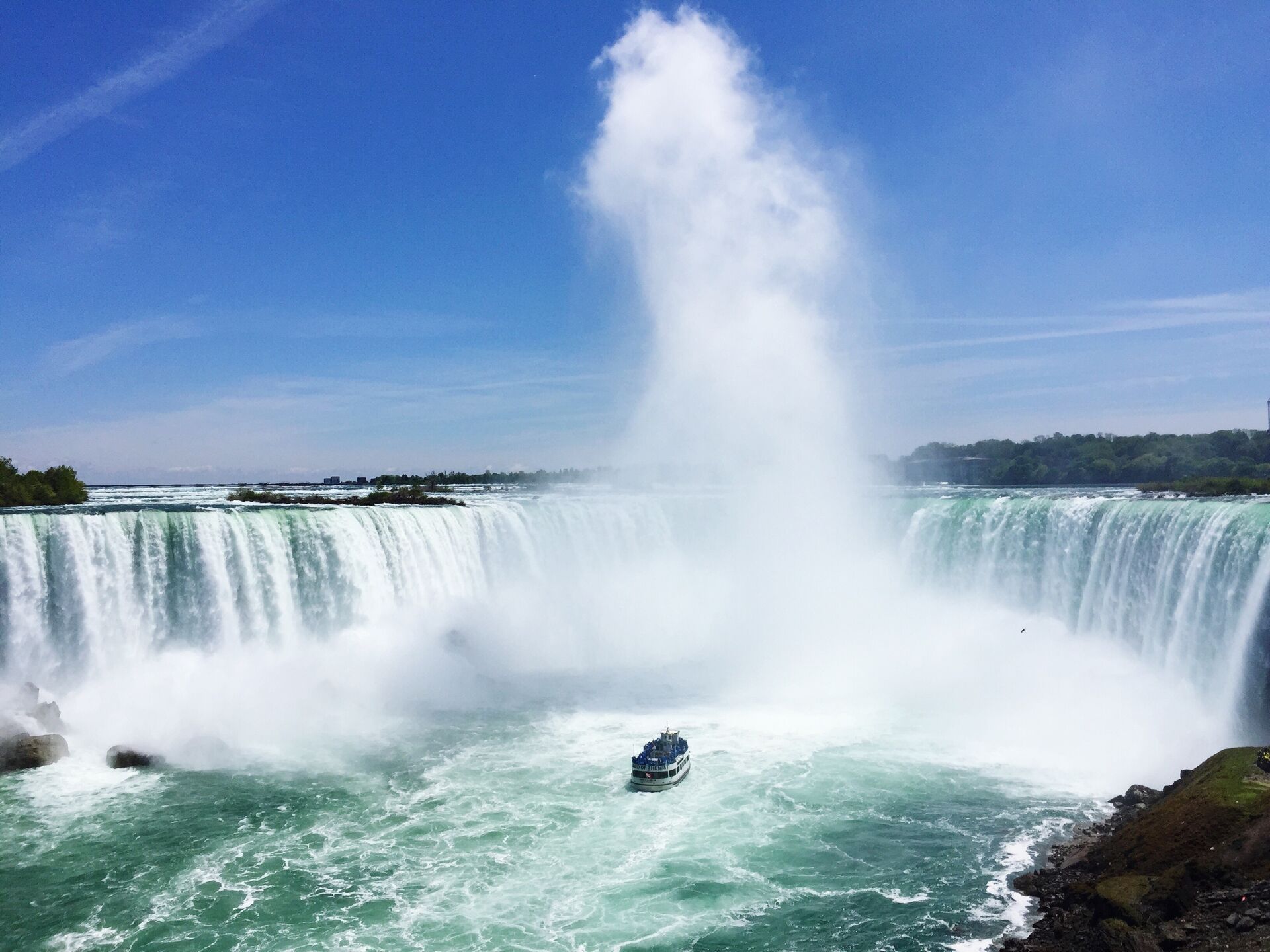 Boat full of tourists approaching Niagara Falls in Canada