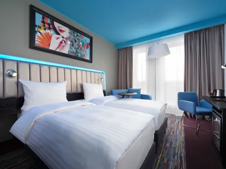 Standard room at Park Inn By Radisson Riga with blue ceiling and blue light headboard