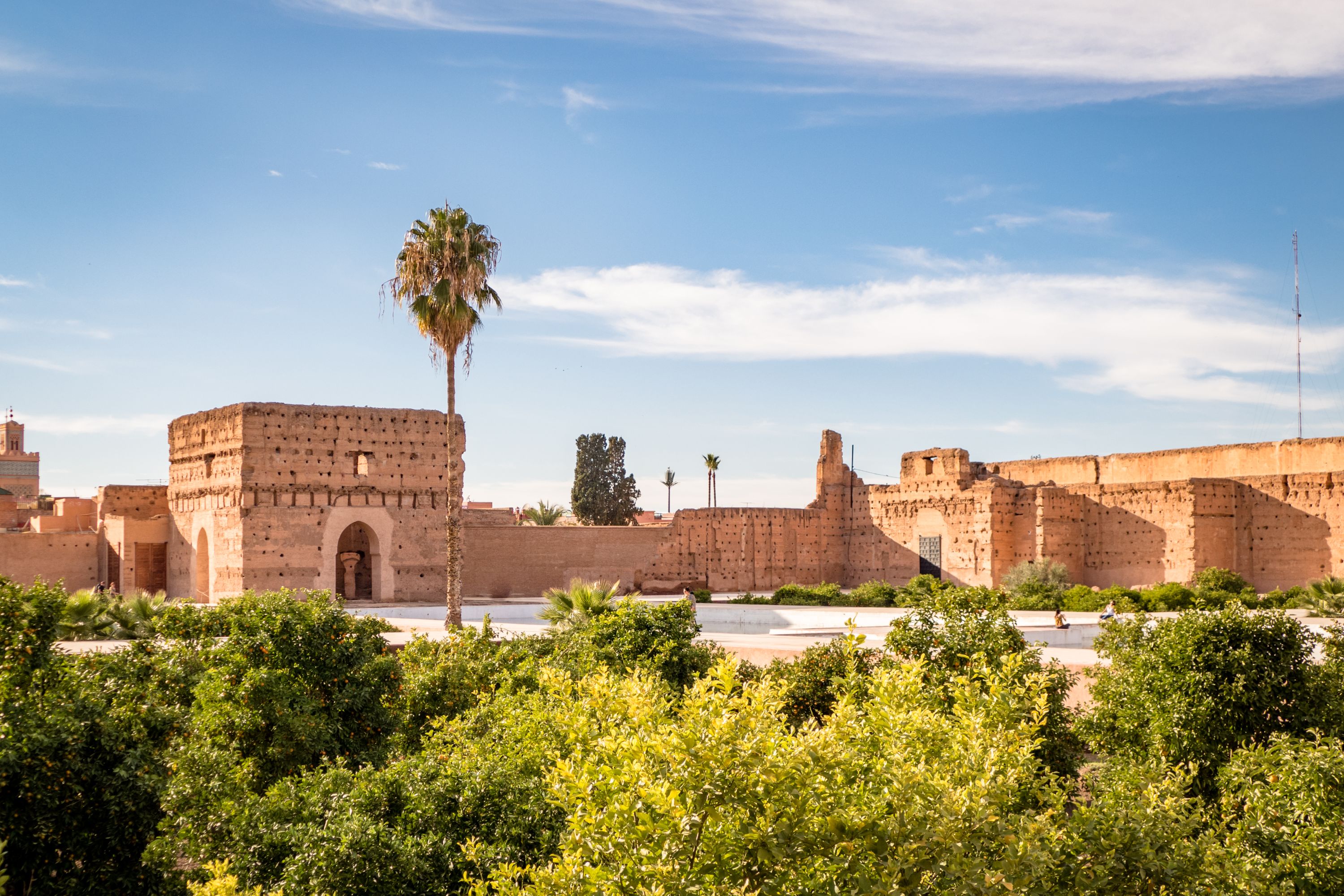 An old palace built of stone with gardens in the foreground in Marrakesh, Morocco.