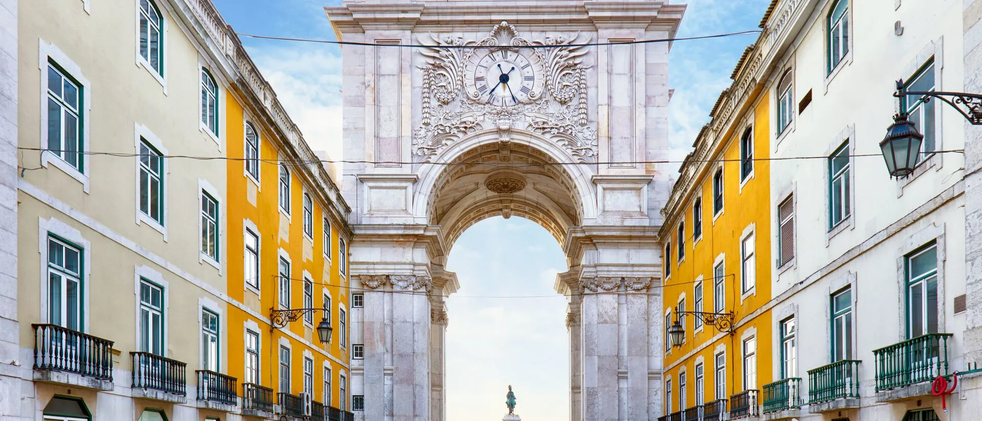Praca Do Comercio arch with yellow buildings either side in Lisbon, Portugal