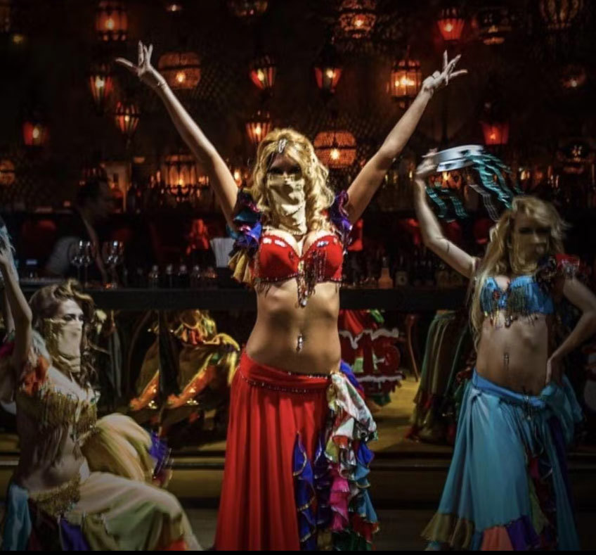 Stage performance with dancers raising their arms under dramatic lighting, Istanbul, Turkey