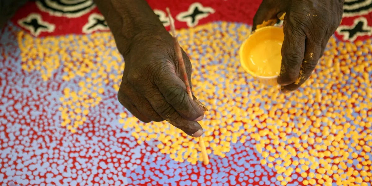 Aboriginal Artist Painting At Ngurratjuta Iltja Ntjarra Many Hands Art Centre